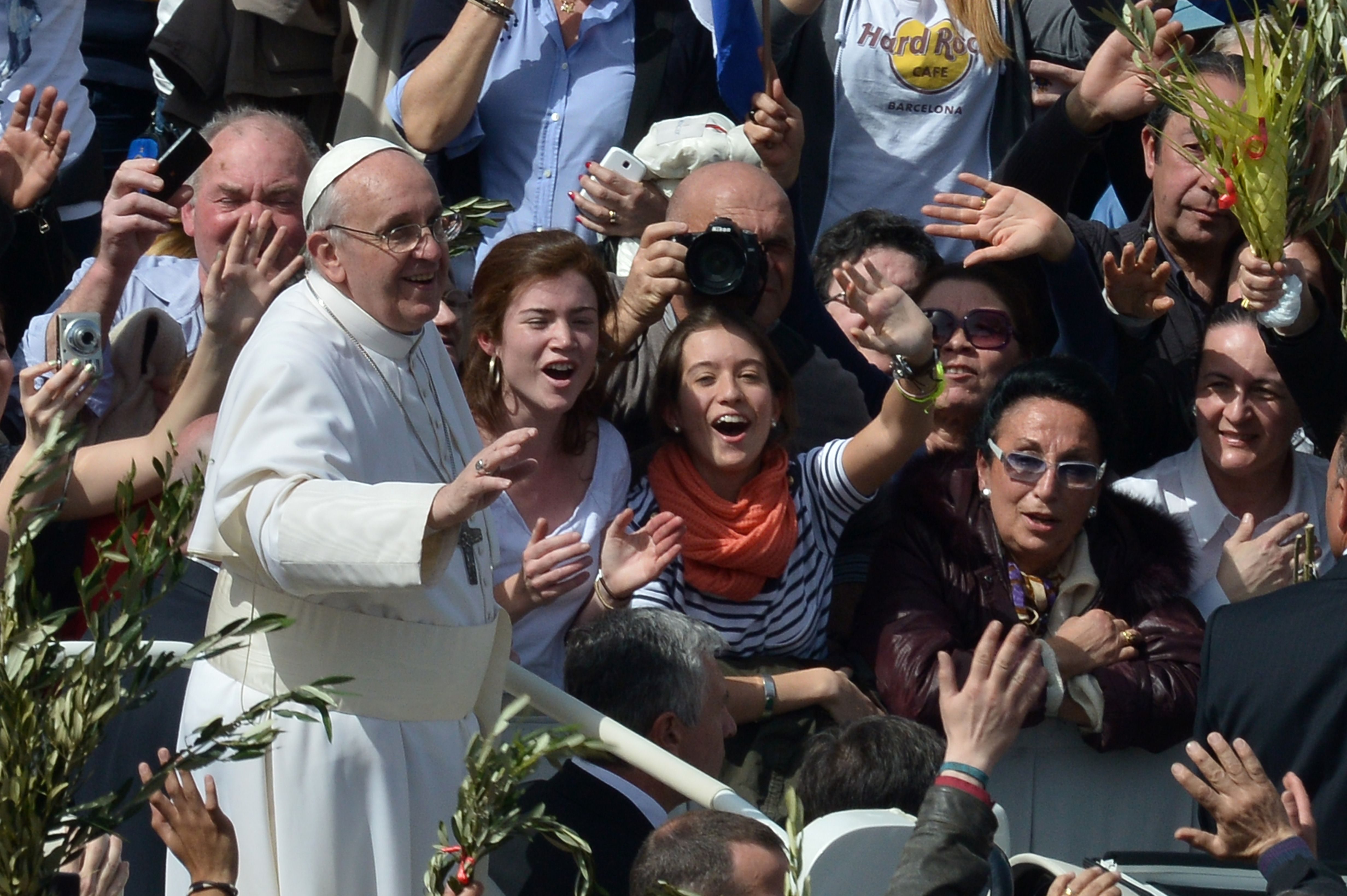 Pope Francis waves to the crowd after a mass on St Peter's square as part of the Palm Sunday celebration on March 24, 2013 at the Vatican. The Palm Sunday marks the start of the holy week of Easter in celebration of the crucifixion and resurrection of Jesus Christ.    AFP PHOTO / GABRIEL BOUYS  VATICAN-POPE-MASS-PALM SUNDAY
