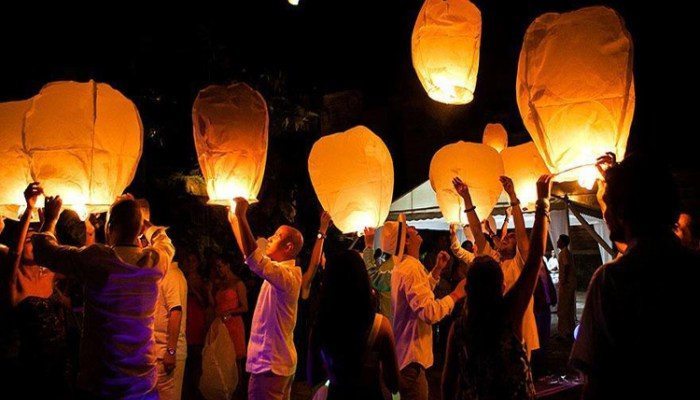 personas-soltando-globos-de-cantoya-de-noche